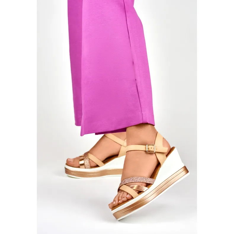 Beige wedge sandals with a shiny strap